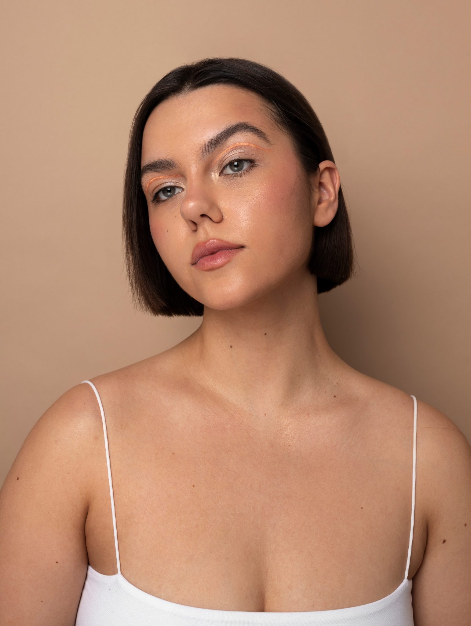 Confident young woman with clear, even skin tone after fractional laser treatment at PUR Skin Clinic