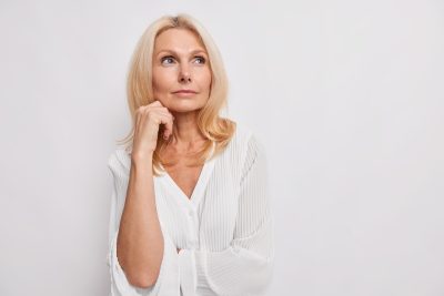 Middle-aged blonde woman with firmer jawline and smoother skin after non-invasive skin tightening at PUR Skin Clinic
