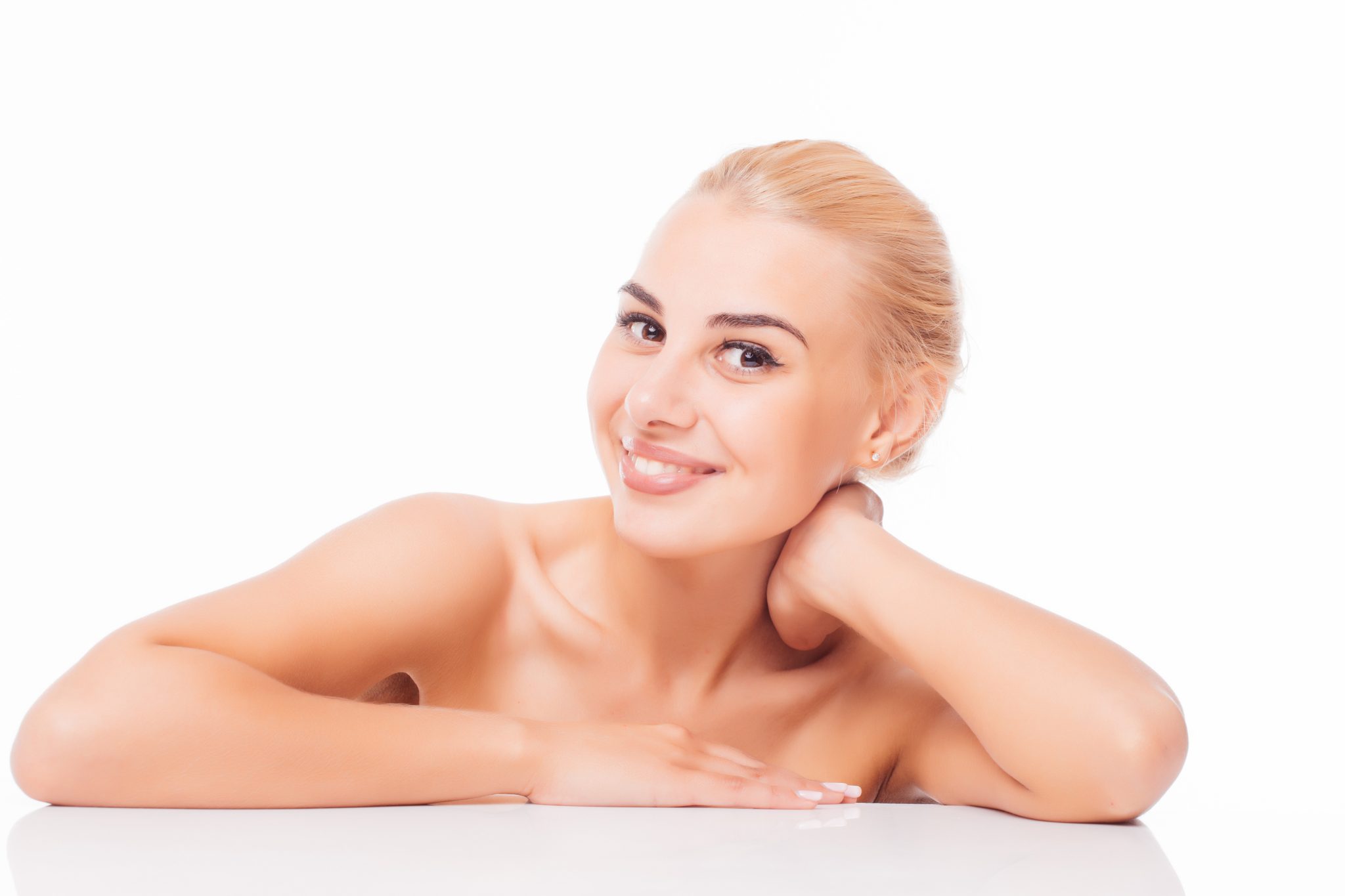 Smiling woman with radiant, refreshed skin after DiamondGlow facial treatment at PUR Skin Clinic