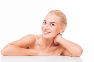 Smiling woman with radiant, refreshed skin after DiamondGlow facial treatment at PUR Skin Clinic