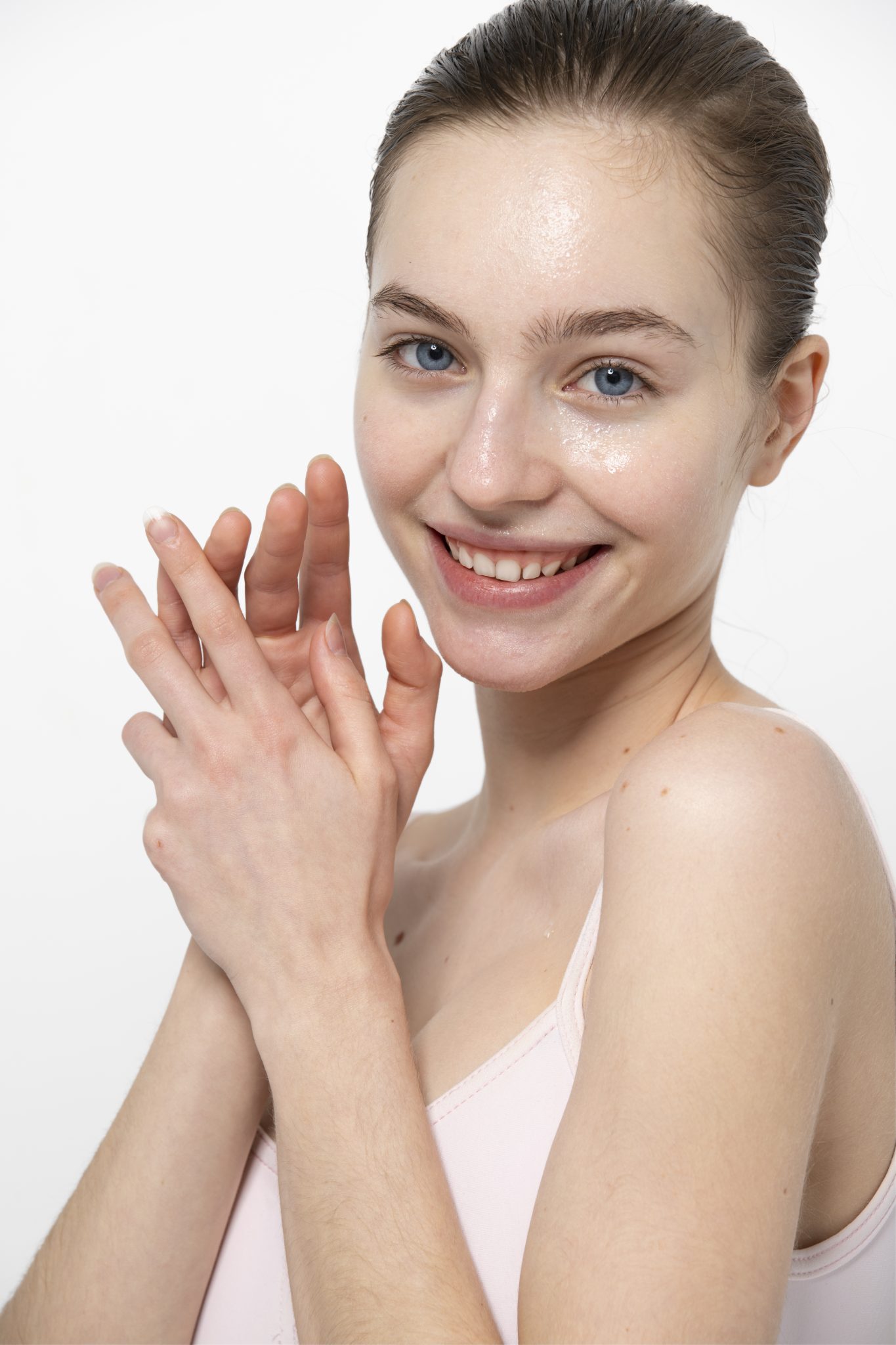 Smiling young woman with radiant, firm skin after SkinTyte laser skin tightening treatment at PUR Skin Clinic